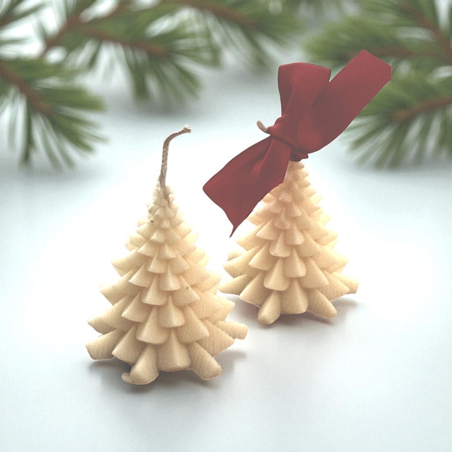Handmade coconut wax candle in a Christmas tree design.