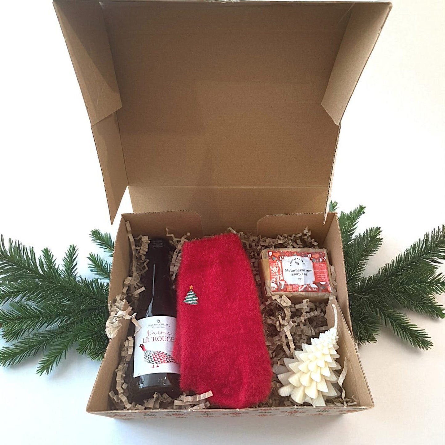 Christmas gift box with wine and handmade treats.