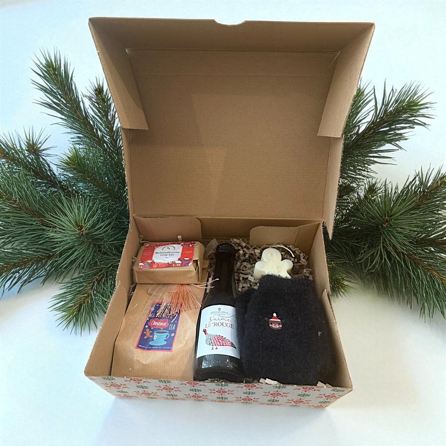 Christmas gift box with wine and handmade treats.