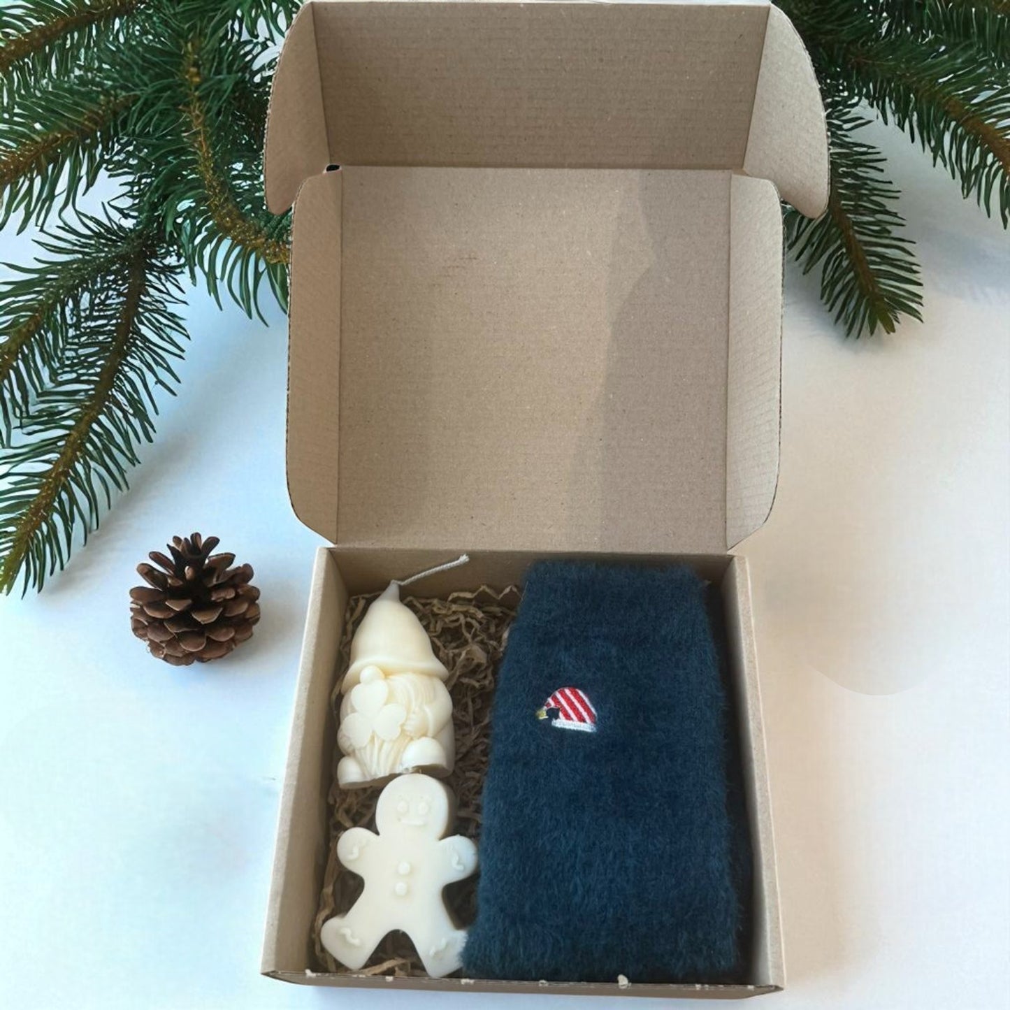Christmas gift boxes with socks and handmade candles.