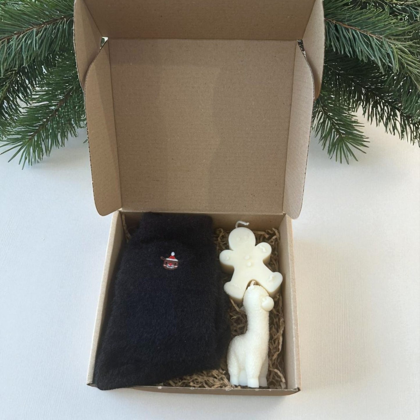 Christmas gift boxes with socks and handmade candles.