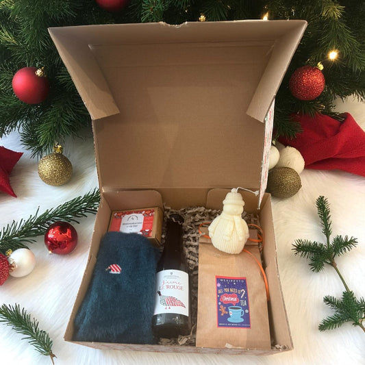 Christmas gift box with wine and handmade treats.
