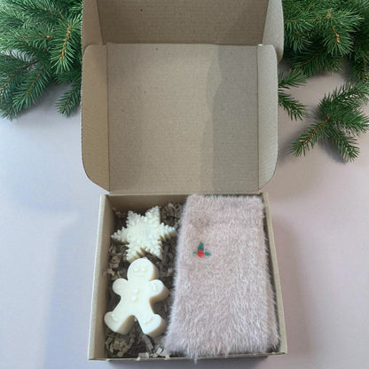 Christmas gift boxes with socks and handmade candles.